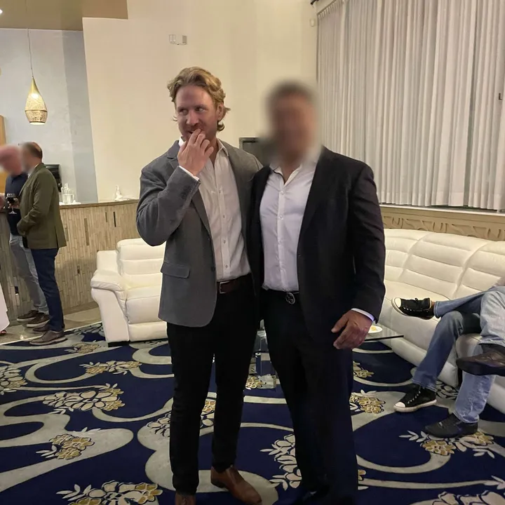 Two members in suits at a hotel