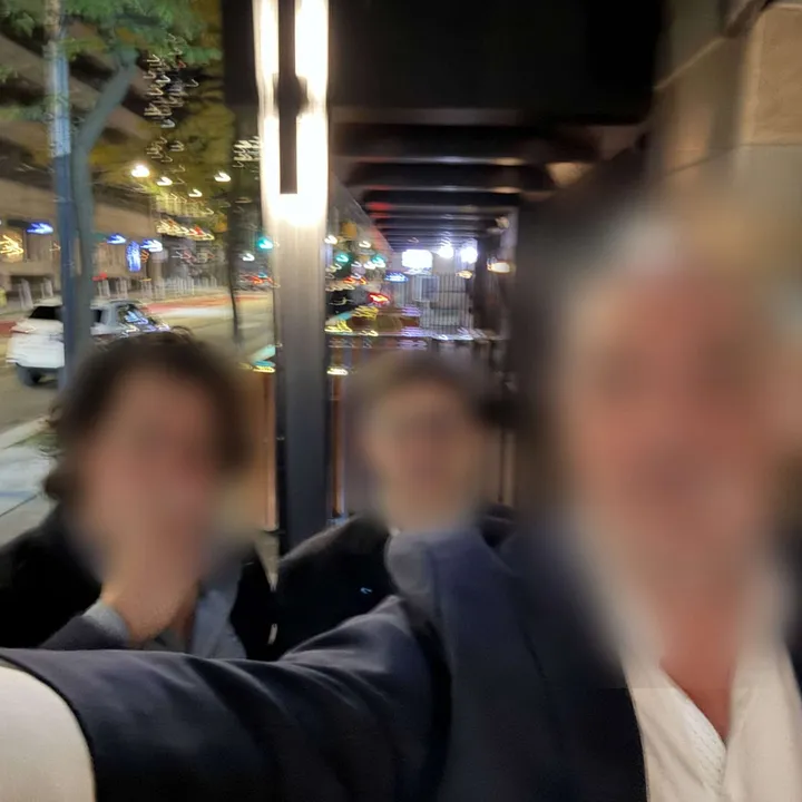 Three members out with cigars at night
