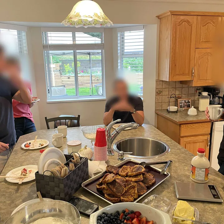 Members cooking brunch together in a kitchen
