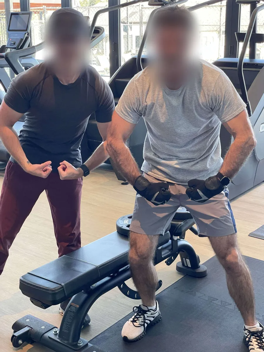 Two members flexing at the gym